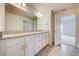 Stylish bathroom featuring granite countertops, double sinks, and wood-look tile flooring at 16511 66Th E Ln, Parrish, FL 34219
