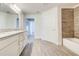 Well-lit bathroom featuring white cabinetry, granite countertops, and a shower-tub combination at 16511 66Th E Ln, Parrish, FL 34219
