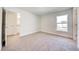 Bright bedroom with soft carpet, a large window, and a convenient location near the bathroom and kitchen at 16511 66Th E Ln, Parrish, FL 34219