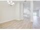 Chandelier-lit dining room with tile floors flows seamlessly into the modern kitchen, offering bright and elegant space at 16511 66Th E Ln, Parrish, FL 34219