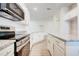 Modern kitchen with stainless appliances, granite counters and an island offers style and functionality at 16511 66Th E Ln, Parrish, FL 34219
