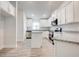 Bright kitchen features white cabinetry, stainless steel appliances, and an island for modern living and style at 16511 66Th E Ln, Parrish, FL 34219