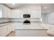 Bright kitchen with stainless steel appliances, white cabinets, granite countertops, and a functional island at 16511 66Th E Ln, Parrish, FL 34219