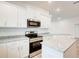 Modern kitchen with white cabinets, stainless steel appliances, granite countertops, and a center island at 16511 66Th E Ln, Parrish, FL 34219