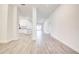 Open-concept living room with tile floors leads to the kitchen and doors, showcasing spaciousness and modern design at 16511 66Th E Ln, Parrish, FL 34219
