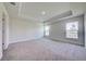 Spacious carpeted main bedroom with tray ceiling and bright windows at 16511 66Th E Ln, Parrish, FL 34219