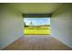 Covered patio showing view of large, grass-covered backyard under a blue sky at 16511 66Th E Ln, Parrish, FL 34219