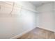 Functional walk-in closet with carpet and shelving, providing organized storage solutions at 16511 66Th E Ln, Parrish, FL 34219