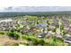 Aerial view of the home near a pond and surrounded by a vibrant community at 17516 Bright Wheat Dr, Lithia, FL 33547