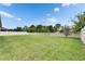 The large backyard features a well-manicured lawn and a white fence surrounding the property at 17516 Bright Wheat Dr, Lithia, FL 33547