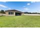 Large backyard featuring lush grass, a white fence, and a view of the rear of the house at 17516 Bright Wheat Dr, Lithia, FL 33547