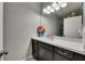 Bright bathroom features a modern vanity with a white countertop and fresh flowers at 17516 Bright Wheat Dr, Lithia, FL 33547