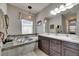 Relaxing bathroom with a soaking tub and double sink vanity at 17516 Bright Wheat Dr, Lithia, FL 33547