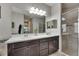 Modern bathroom with a double sink vanity and walk-in shower at 17516 Bright Wheat Dr, Lithia, FL 33547