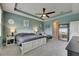 This primary bedroom has a tray ceiling, fan, and sitting area at 17516 Bright Wheat Dr, Lithia, FL 33547
