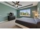 This spacious bedroom has a ceiling fan, dresser, and large window at 17516 Bright Wheat Dr, Lithia, FL 33547