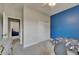 Bright bedroom featuring an eye-catching blue accent wall with adjacent closet and doorway at 17516 Bright Wheat Dr, Lithia, FL 33547