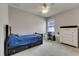 Inviting bedroom with blue bedding, a black bedframe and matching dresser, and a dedicated workspace at 17516 Bright Wheat Dr, Lithia, FL 33547