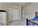 Bedroom with a closet and light gray walls, features a blue bedspread and plenty of space at 17516 Bright Wheat Dr, Lithia, FL 33547