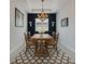 Formal dining room with blue accent wall, modern light fixture and table with four chairs at 17516 Bright Wheat Dr, Lithia, FL 33547