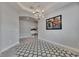 Neutral dining area with light tile, modern lighting, art, and mudroom access at 17516 Bright Wheat Dr, Lithia, FL 33547