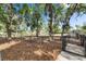 Fenced dog park area with mature trees and leaves on the ground providing a shady spot for pets to play at 17516 Bright Wheat Dr, Lithia, FL 33547
