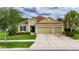 Charming single-story home with a well-manicured lawn, mature landscaping, and a 3-car garage at 17516 Bright Wheat Dr, Lithia, FL 33547