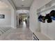 Hallway with decorative lighting, hallway storage unit, and view of living space at 17516 Bright Wheat Dr, Lithia, FL 33547