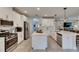 Spacious kitchen with stainless steel appliances, island, and stylish pendant lights at 17516 Bright Wheat Dr, Lithia, FL 33547