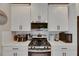 White kitchen cabinets complement stainless steel appliances and subway tile backsplash at 17516 Bright Wheat Dr, Lithia, FL 33547