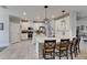 Bright eat-in kitchen with large island, pendant lights, stainless appliances and white cabinets at 17516 Bright Wheat Dr, Lithia, FL 33547