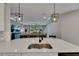 Modern kitchen island features a stainless steel sink and stylish pendant lighting at 17516 Bright Wheat Dr, Lithia, FL 33547