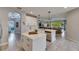 Open-concept kitchen with central island, stainless appliances, and seamless flow to living spaces at 17516 Bright Wheat Dr, Lithia, FL 33547