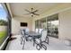 The covered lanai features a ceiling fan, table, chairs, and sliding doors to the interior at 17516 Bright Wheat Dr, Lithia, FL 33547