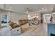Expansive living room with tile flooring and views of the modern kitchen area at 17516 Bright Wheat Dr, Lithia, FL 33547