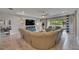 Comfortable living room with large sectional sofa, television, and open access to lanai at 17516 Bright Wheat Dr, Lithia, FL 33547