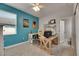 Bright home office boasts a blue accent wall and dual desk setup for productivity with natural light at 17516 Bright Wheat Dr, Lithia, FL 33547