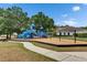 Outdoor playground area with slides, swings, and play equipment for children in a safe and engaging environment at 17516 Bright Wheat Dr, Lithia, FL 33547