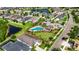 Aerial view of the community pool and covered seating area with lounge chairs and lush landscaping at 17516 Bright Wheat Dr, Lithia, FL 33547