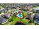 Aerial view of the community pool and a covered seating area surrounded by lush landscaping at 17516 Bright Wheat Dr, Lithia, FL 33547