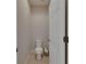 Neutral-toned powder room featuring a toilet and a stock of toilet paper at 17516 Bright Wheat Dr, Lithia, FL 33547