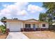 Charming single-story home with a brick facade and attached one car garage in a quiet neighborhood at 1801 Mississippi Ne Ave, St Petersburg, FL 33703