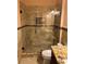 This bathroom features a seamless glass shower with decorative tiling and neutral tones at 18104 Sweet Jasmine Dr, Tampa, FL 33647