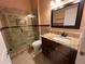 Elegant bathroom features a glass shower, granite countertops, and a framed mirror at 18104 Sweet Jasmine Dr, Tampa, FL 33647