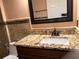 Bathroom featuring granite counters and decorative mosaic tile backsplash at 18104 Sweet Jasmine Dr, Tampa, FL 33647
