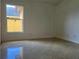 A light-filled bedroom features glossy tiled floors and natural lighting at 18104 Sweet Jasmine Dr, Tampa, FL 33647
