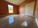 A spacious bedroom features tile floors, a window, and closet at 18104 Sweet Jasmine Dr, Tampa, FL 33647