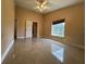 Spacious bedroom features a ceiling fan, window, and an open doorway at 18104 Sweet Jasmine Dr, Tampa, FL 33647
