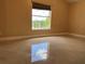 A sunlit bedroom features tiled floors and backyard views from the window at 18104 Sweet Jasmine Dr, Tampa, FL 33647