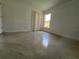 A well lit bedroom featuring glossy floors, closet, and a window at 18104 Sweet Jasmine Dr, Tampa, FL 33647